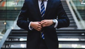Man at the bottom of stairs with a suit on