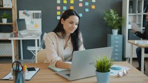 Woman Looking at Compuer while working in the office